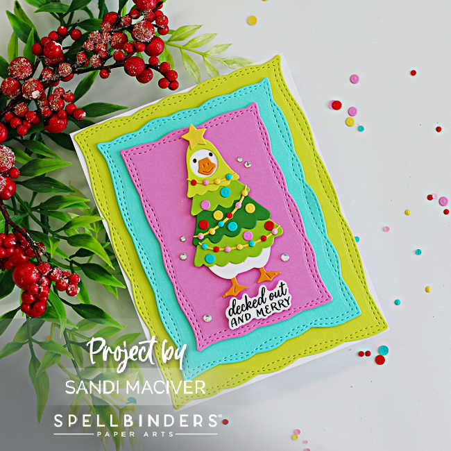 Handmade Spellbinders Lit with Joy Christmas card featuring a goose dressed as a Christmas tree, layered green, aqua, and purple stitched panels, and silver gems.