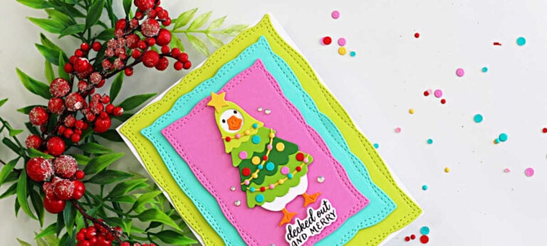 Handmade Christmas card featuring a silly goose dressed as a Christmas tree, framed by colorful stitched zigzag panels, created with the Spellbinders Lit with Joy dies.