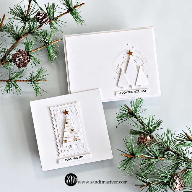 Two white-and-gold Simple Trees Christmas cards featuring dimensional die-cut trees, gold thread and stars, with “Love and Joy” and “A Joyful Holiday” sentiments, styled with pine branches and pinecones.