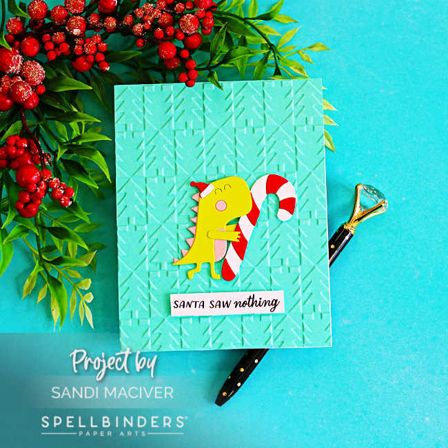 Spellbinders Candy Cane Dash Christmas card featuring a cute dinosaur with a candy cane and Santa hat on a mint Holiday Check 3D embossed background.