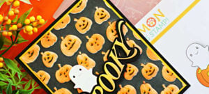 Halloween card featuring orange jack-o’-lanterns on a black embossed background, layered Spooky sentiment, and white ghost die-cut.